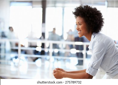Portrait of smiling woman in office, side view