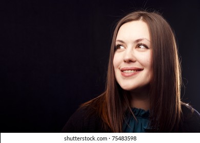 Portrait Of A Smiling Woman On Black Background. Close-up.
