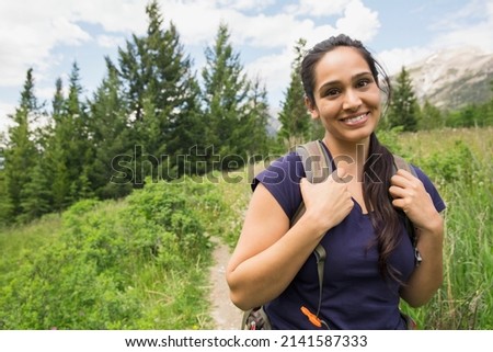 Portrait of smiling woman on hiking trail