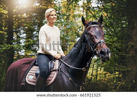 Similar – Image, Stock Photo Brown horse walking on a green field in cloudy weather