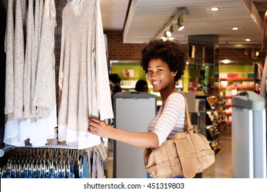 Portrait of smiling woman shopping in clothing store