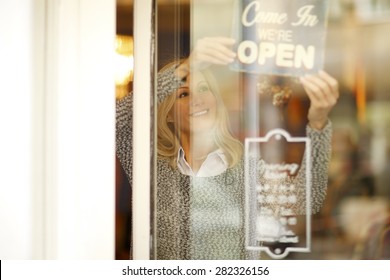 Portrait Of Smiling Woman Standing Behind Her Clothing Store Shop Window. Small Business. 