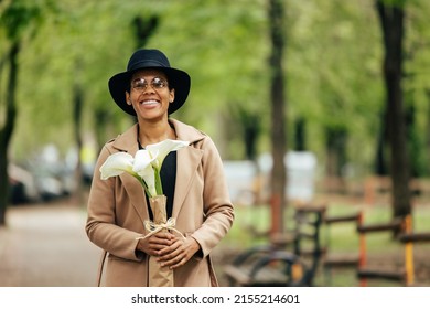 Portrait Of A Smiling Woman, Standing Straight, Wearing A Hat And Sunglasses.