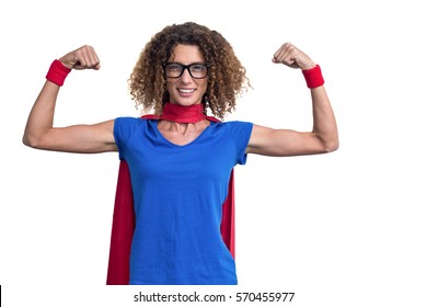 Portrait of smiling woman in superhero costume while flexing muscles on white background - Powered by Shutterstock