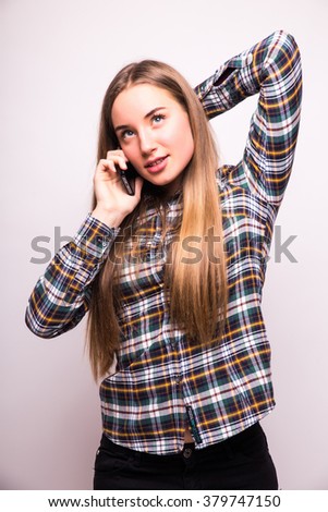 Portrait of a smiling woman talking on the phone 