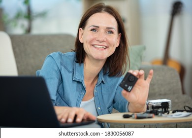 portrait of smiling woman testing her new camera - Powered by Shutterstock