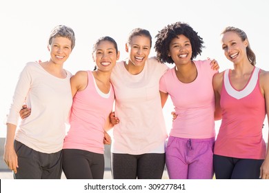 Portrait of smiling women wearing pink for breast cancer in parkland