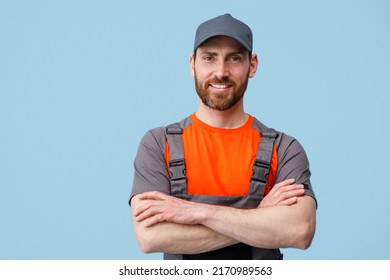 Portrait of smiling workerman in uniform with crossed hands looking at camera - Shutterstock ID 2170989563