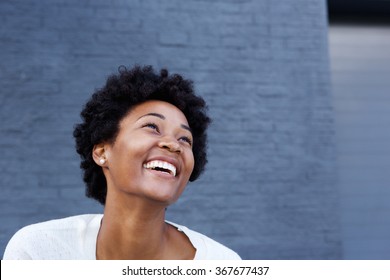 Portrait Of Smiling Young African Woman Looking Away At Copy Space
