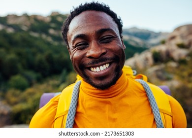 A portrait of a smiling young black mountain hiker with full gear - Shutterstock ID 2173651303