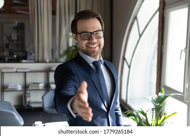 Portrait of smiling young Caucasian male boss or director in formal suit stretch hand greeting get acquainted with client, happy businessman meet welcome new employee, recruitment concept - Shutterstock ID 1779265184