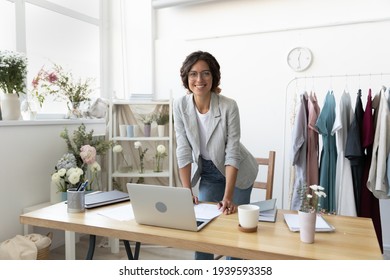 Portrait of smiling young Caucasian successful female fashion designer pose at modern cozy home office desk. Happy confident millennial businesswoman stylist or tailor work at creative workplace. - Powered by Shutterstock