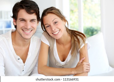 Portrait Of Smiling Young Couple At Home