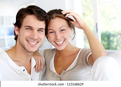 Portrait Of Smiling Young Couple At Home