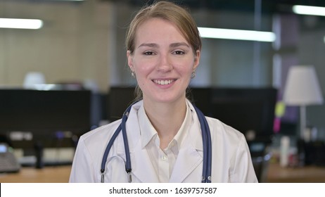 Portrait Of Smiling Young Female Doctor Looking At Camera