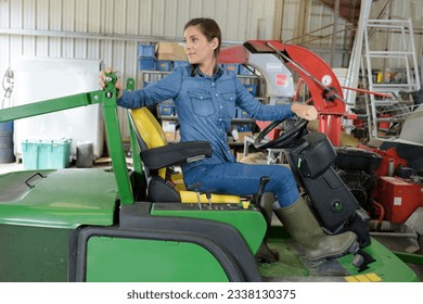 portrait of smiling young female mechanic inspecting tractor - Powered by Shutterstock