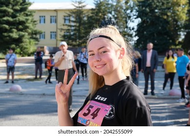 Portrait Of A Smiling Young Girl (teenager) Athlete With Problem Skin (acne) Posing Confidently Before The Start (track And Field Race). Izyum, Ukraine - 09.12.2021