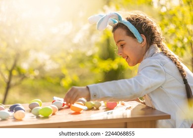 portrait of smiling young girl wearing traditional bunny ears headband for Easter. spring time, anpril or may - Powered by Shutterstock