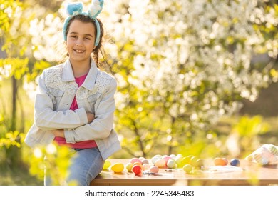 portrait of smiling young girl wearing traditional bunny ears headband for Easter. spring time, anpril or may - Powered by Shutterstock