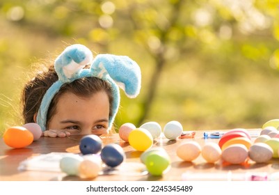 portrait of smiling young girl wearing traditional bunny ears headband for Easter. spring time, anpril or may - Powered by Shutterstock