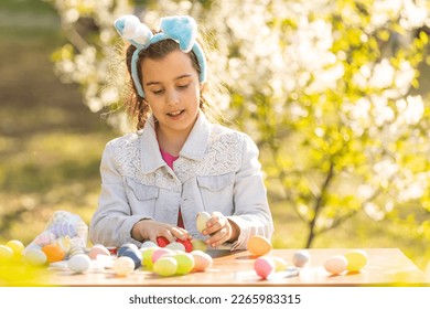 portrait of smiling young girl wearing traditional bunny ears headband for Easter. spring time, anpril or may - Powered by Shutterstock