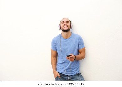 Portrait Of A Smiling Young Man With Mobile Phone And Headphones