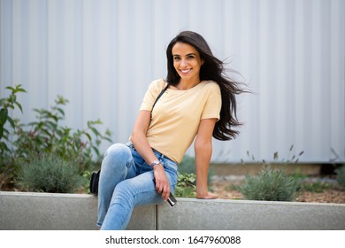 Portrait Smiling Young North African Woman Sitting Outside 