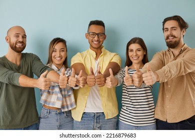 Portrait of smiling young people on green studio background show thumb up give recommendation. Happy multiethnic diverse friends recommend good study course or school. Education, friendship. - Powered by Shutterstock