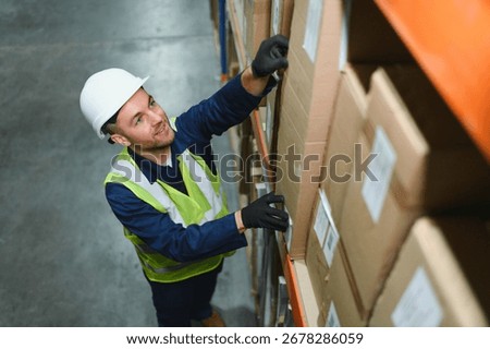 portrait of a smiling young warehouse worker working in a cash and carry wholesale store.