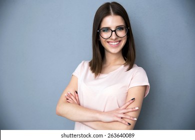 Portrait Of A Smiling Young Woman With Arms Folded