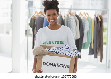 Portrait Of A Smiling Young Woman With Clothes Donation