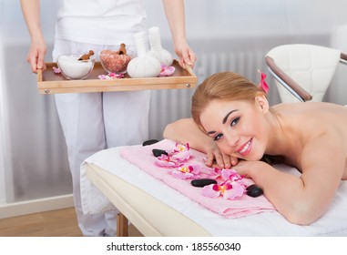 Portrait Of Smiling Young Woman Relaxing In Spa