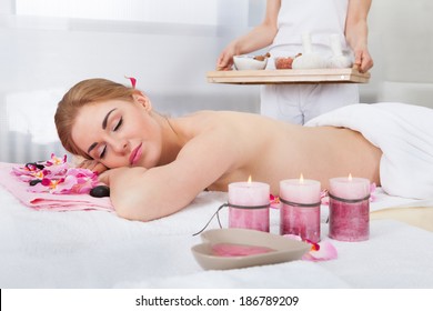 Portrait Of Smiling Young Woman Relaxing In Spa