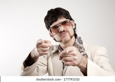 Portrait Of A Smug Retro Man In A 1970s Leisure Suit And Sunglasses Pointing To The Camera 