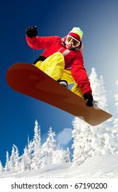 Portrait Of Snowboarder Doing Extreme Trick