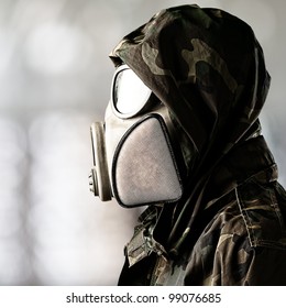 Portrait Of Soldier Wearing Gas Mask Over Abstract Background