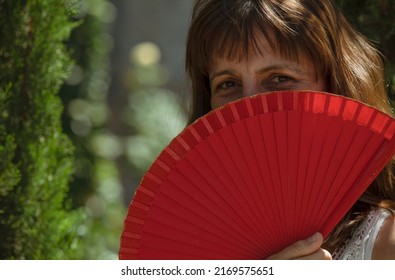 Portrait Of Spanish Woman With Red Hand Fan