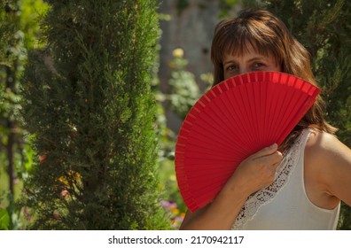 Portrait Of Spanish Woman With Red Hand Fan