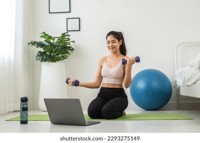 Portrait sport asian beauty body slim woman in sportswear sitting relax and girl do fitness exercise, yoga, dumbbell with laptop computer in bedroom at home.Diet concept.Fitness and healthy - Powered by Shutterstock