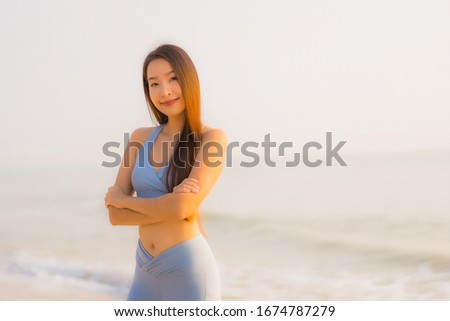Portrait sport young asian woman prepare exercise or run on the beach sea ocean for health