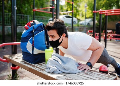 Portrait Sports Arabian Man In Black Medical Face Mask Doing Workout Exercises In Outdoor Gym Place During Coronavirus Quarantine.