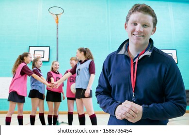 Portrait Of Sports Coach With Pupils Standing In Gymnasium