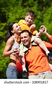 Portrait Of Sporty Family Having Good Time Outdoors