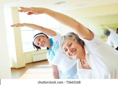 Portrait of sporty females doing physical exercise in sport gym - Powered by Shutterstock