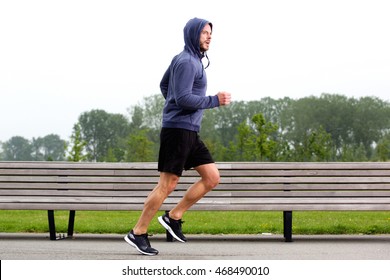 Portrait Of Sporty Older Man Running In Park