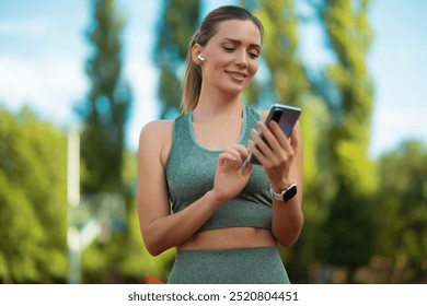 Portrait of sporty woman holding her phone - Powered by Shutterstock