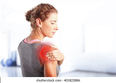 Portrait Of Sporty Woman Putting Her Hand On Red Spots On While Has Sport Injury In Her Shoulder.