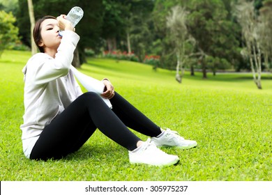 Portrait Of Sporty Woman Sitting And Get Refreshment After Workout With Copy Space