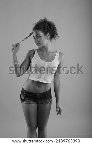 Similar – Brunette surfer woman with top and bikini holding surfboard