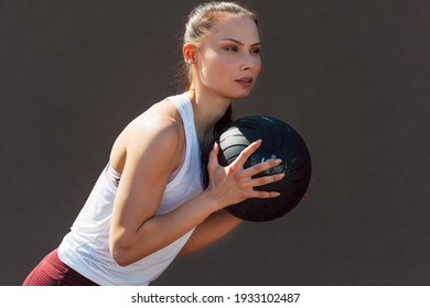 Portrait Of A Sporty Young Woman Doing Exercises With A Medicine Ball Outdoors On A Sunny Day. Fitness Female Exercising Fitness Ball Outside.